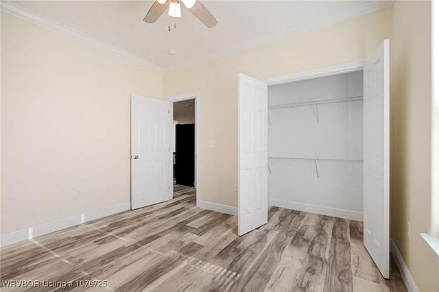 unfurnished bedroom with ceiling fan, light wood-type flooring, crown molding, and a closet