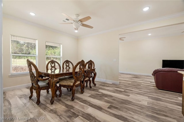 dining room featuring ceiling fan, ornamental molding, and light wood-type flooring