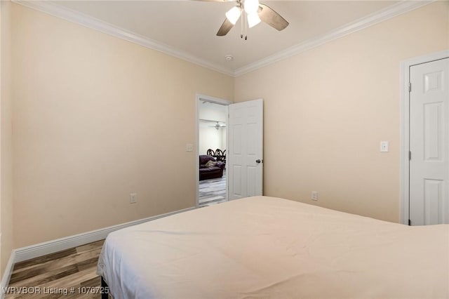 bedroom featuring ceiling fan, hardwood / wood-style flooring, and ornamental molding