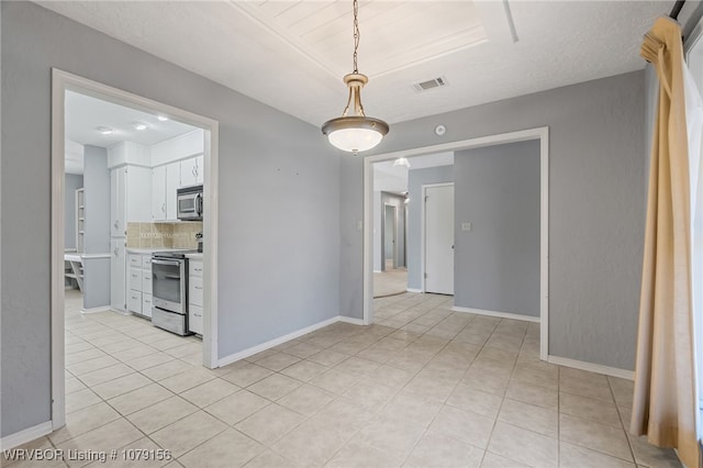 interior space with visible vents, baseboards, and light tile patterned floors