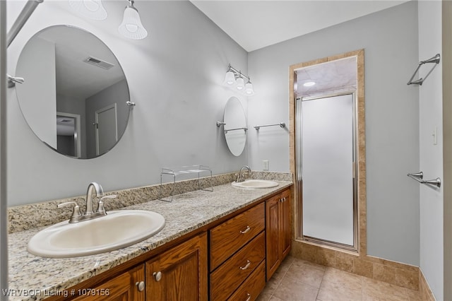 bathroom featuring tile patterned floors, visible vents, a sink, and double vanity