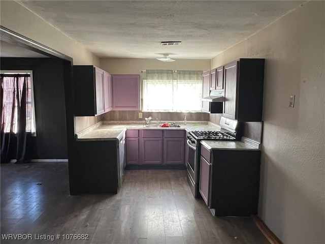 kitchen with appliances with stainless steel finishes and dark wood-type flooring