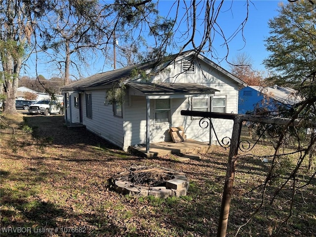 view of home's exterior featuring a fire pit