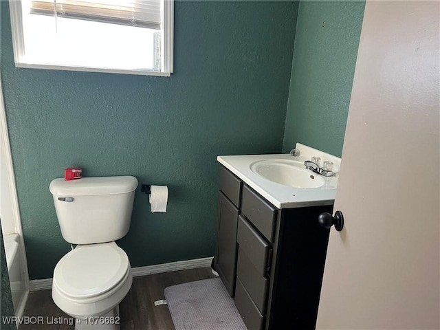 bathroom with hardwood / wood-style floors, vanity, and toilet