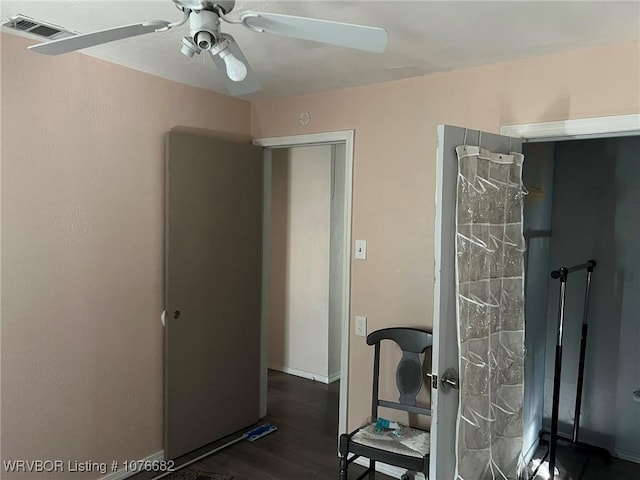 workout area featuring dark hardwood / wood-style flooring and ceiling fan