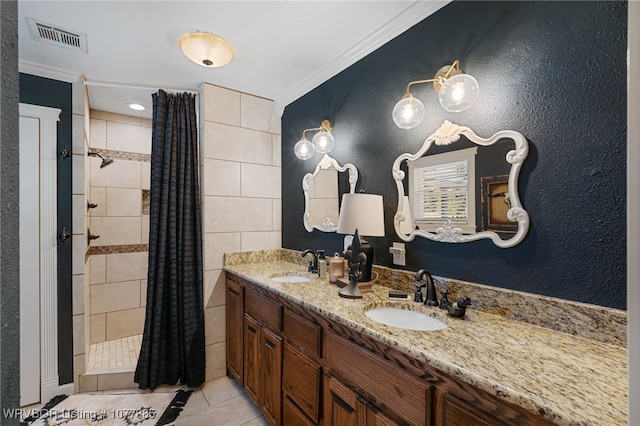 bathroom with a shower with shower curtain, vanity, tile patterned floors, and crown molding