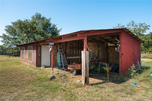 view of outbuilding featuring a lawn