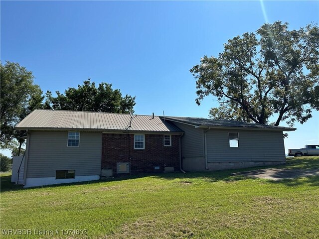 rear view of property featuring a yard