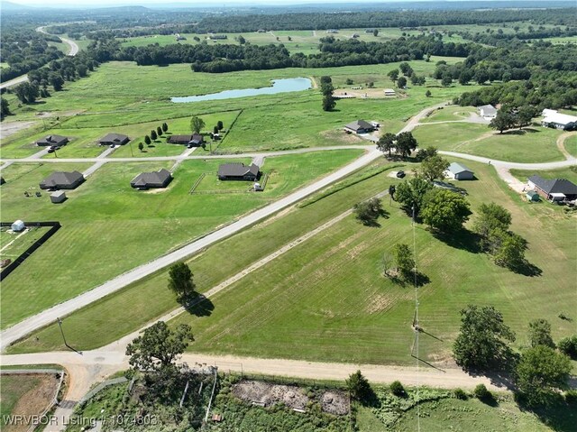 birds eye view of property with a water view and a rural view