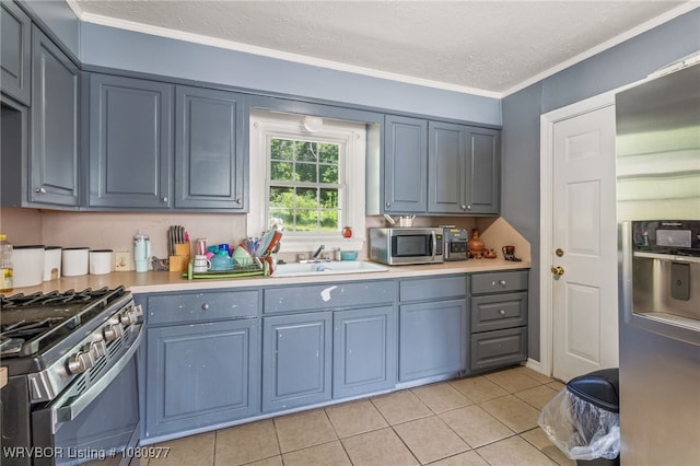 4209 Old Jenny Lind Rd, Fort Smith, AR 72901 - kitchen featuring appliances with stainless steel finishes, a sink, light tile patterned floors, light countertops, and crown molding