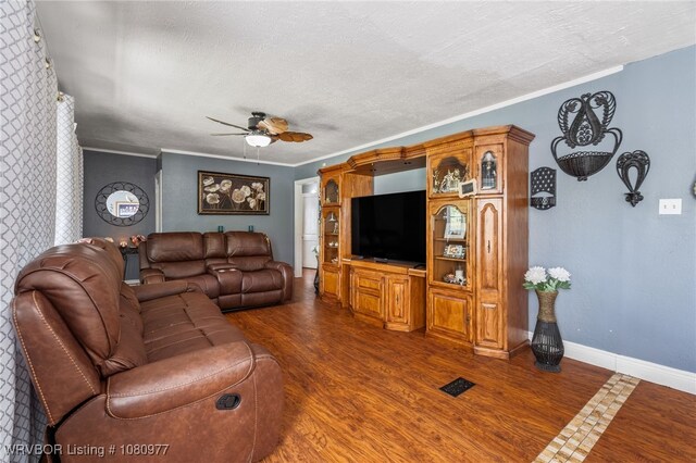 4209 Old Jenny Lind Rd, Fort Smith, AR 72901 - living room with a ceiling fan, dark wood-style flooring, a textured ceiling, crown molding, and baseboards