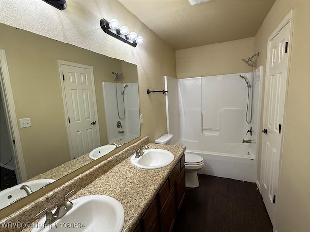 full bath with a sink, shower / tub combination, and wood finished floors