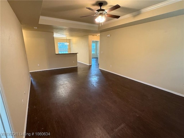 unfurnished room with crown molding, baseboards, dark wood-style flooring, and a ceiling fan
