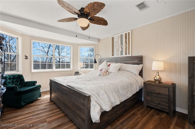 bedroom with dark wood finished floors, baseboards, visible vents, and ceiling fan