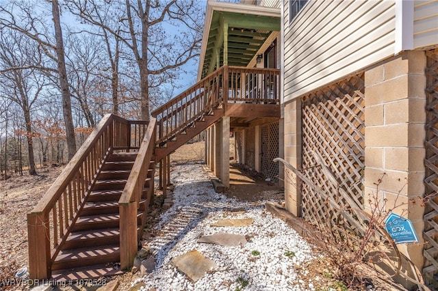 view of side of home with a wooden deck and stairs