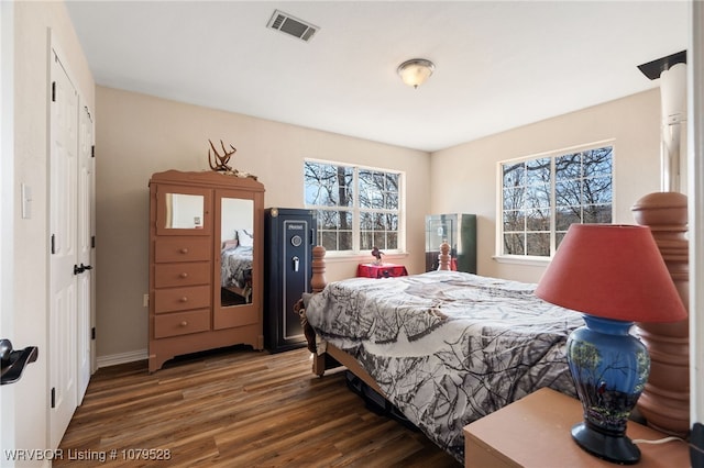 bedroom with visible vents and wood finished floors