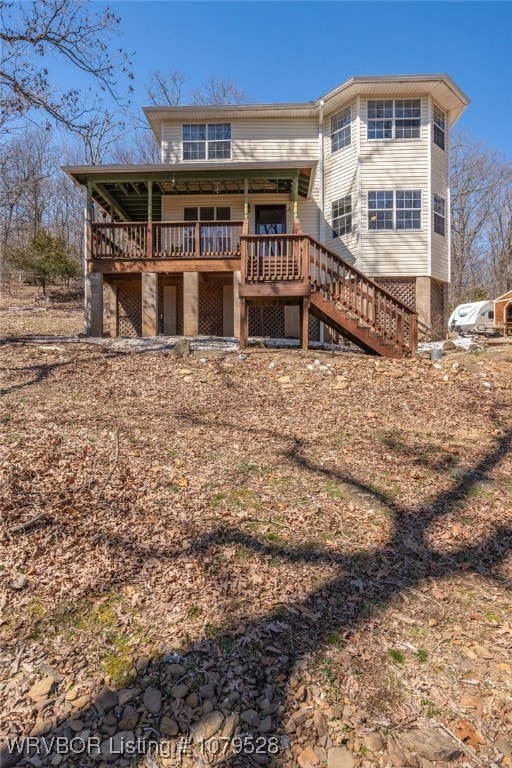 rear view of property featuring stairs and a deck