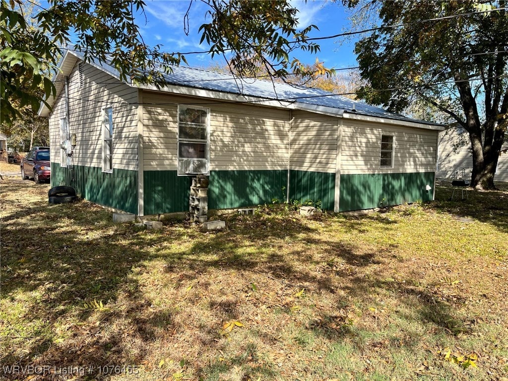 view of side of home featuring a yard