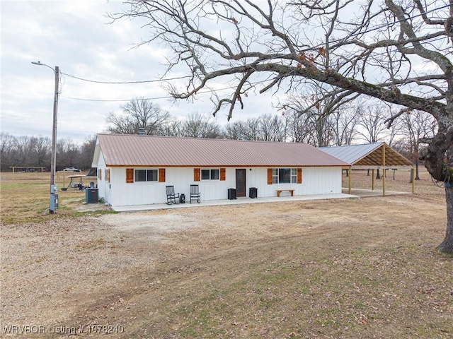 ranch-style home with a front lawn and central AC