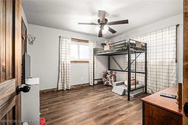 bedroom with dark wood-type flooring and a textured ceiling