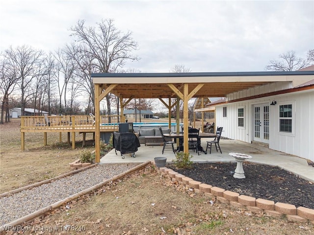 view of patio / terrace featuring french doors, area for grilling, and a wooden deck