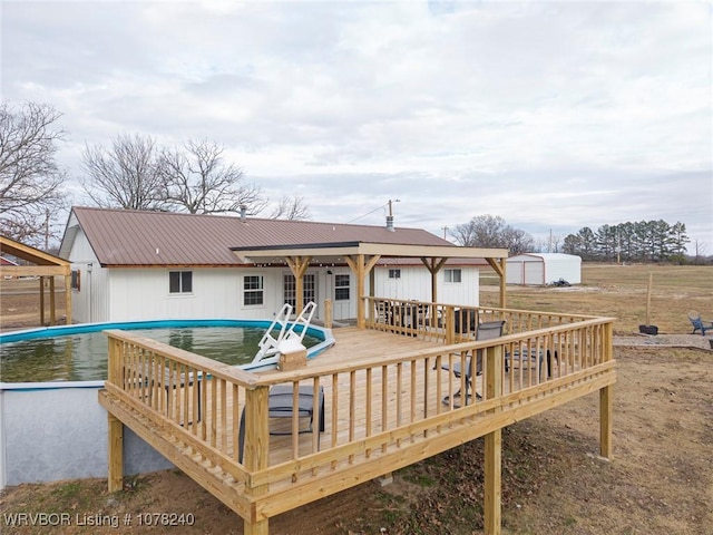 rear view of property with a swimming pool side deck