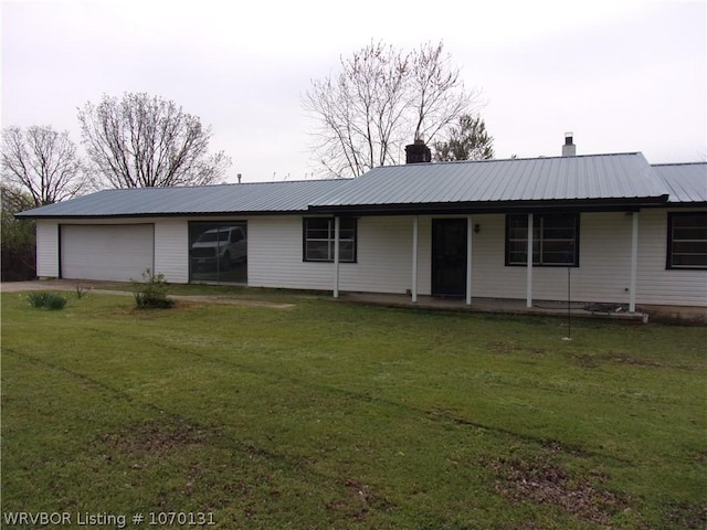 ranch-style home with a garage and a front lawn