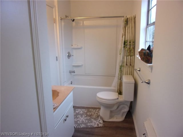 full bathroom with vanity, hardwood / wood-style flooring, toilet, and shower / bath combo with shower curtain