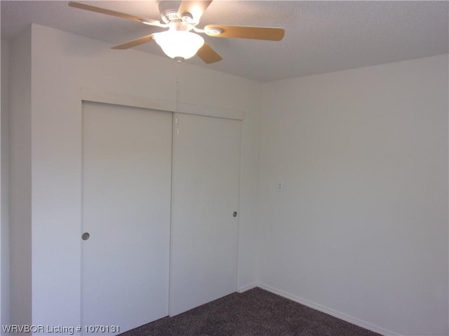 unfurnished bedroom featuring ceiling fan, carpet floors, and a closet