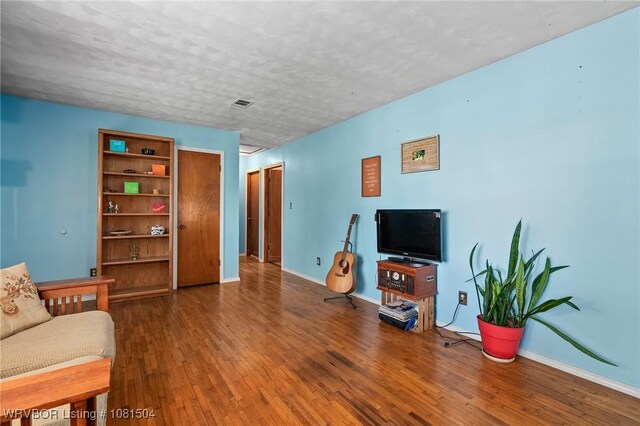 1310 Pigeon Creek Rd, Mountainburg, AR 72946 - living room with wood-type flooring and a textured ceiling