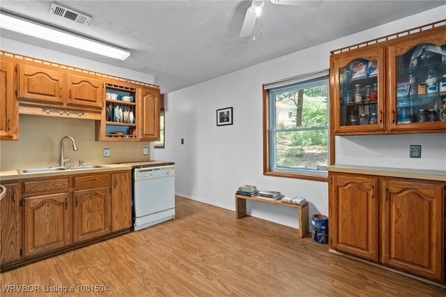 1310 Pigeon Creek Rd, Mountainburg, AR 72946 - kitchen featuring dishwasher, brown cabinetry, light wood-style flooring, and light countertops