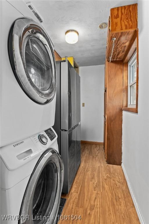 1310 Pigeon Creek Rd, Mountainburg, AR 72946 - laundry area with stacked washer and clothes dryer and light wood-style flooring