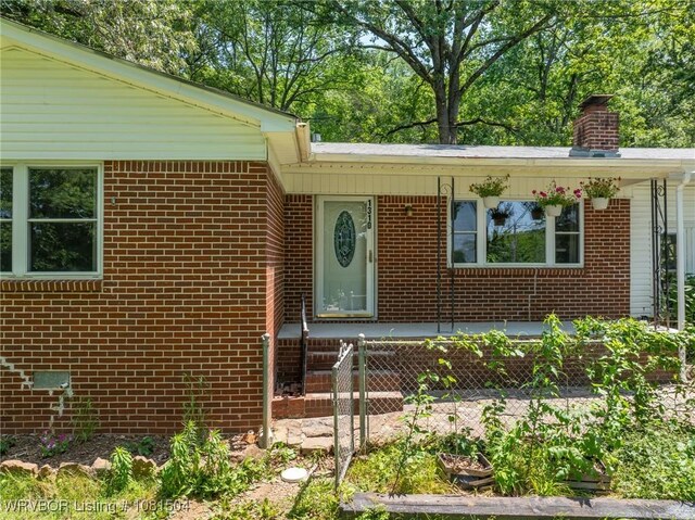 1310 Pigeon Creek Rd, Mountainburg, AR 72946 - property entrance featuring brick siding and a chimney