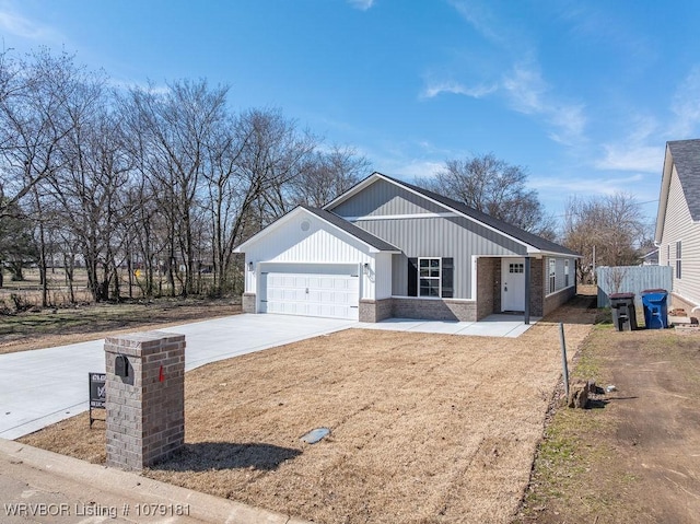 view of front of home with a garage, brick siding, and driveway