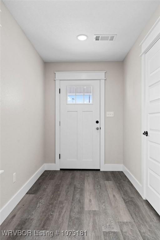 entryway with wood finished floors, visible vents, and baseboards