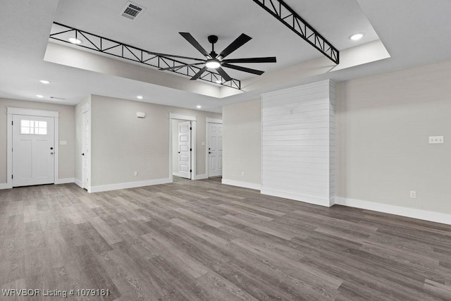 unfurnished living room with ceiling fan, recessed lighting, wood finished floors, visible vents, and baseboards