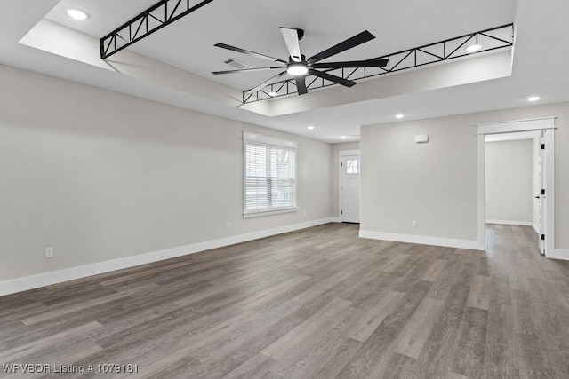 empty room with recessed lighting, visible vents, a ceiling fan, wood finished floors, and baseboards