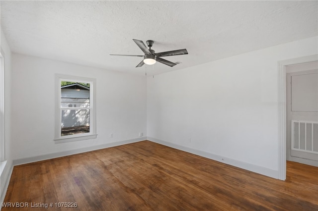 empty room featuring a textured ceiling, hardwood / wood-style flooring, and ceiling fan