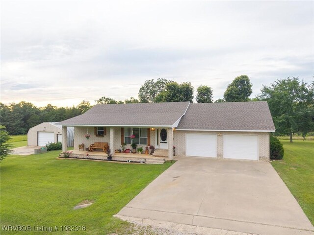 106078 S 4715th Rd, Muldrow, OK 74948 - single story home with a porch, a garage, brick siding, a front yard, and driveway