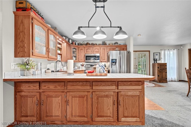 106078 S 4715th Rd, Muldrow, OK 74948 - kitchen with stainless steel appliances, glass insert cabinets, a peninsula, tile counters, and light carpet