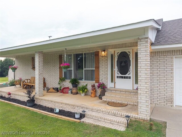 106078 S 4715th Rd, Muldrow, OK 74948 - entrance to property featuring covered porch, brick siding, a shingled roof, and an attached garage