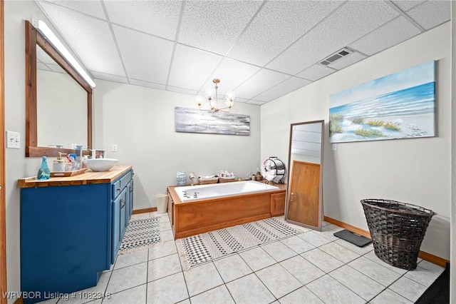 106078 S 4715th Rd, Muldrow, OK 74948 - bathroom with double vanity, a garden tub, a drop ceiling, tile patterned floors, and a chandelier