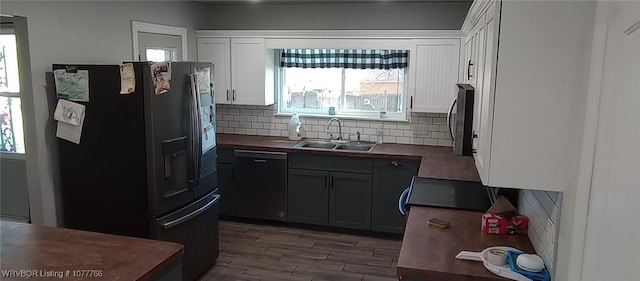 kitchen featuring gray cabinetry, black dishwasher, refrigerator with ice dispenser, backsplash, and white cabinets