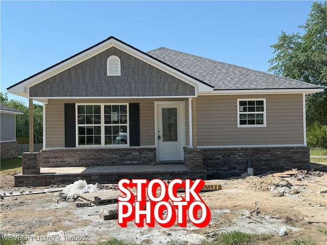 view of front of house featuring a porch and roof with shingles