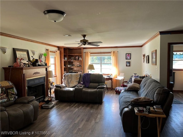 living room with ceiling fan, built in features, dark wood-type flooring, and ornamental molding