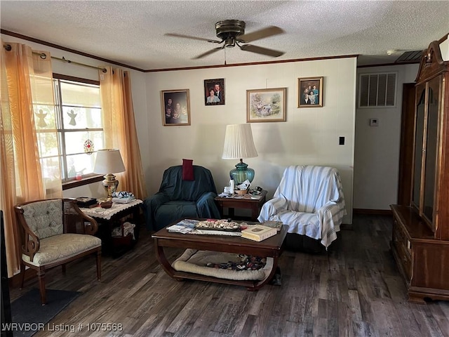 sitting room featuring ceiling fan, crown molding, dark wood-type flooring, and a textured ceiling