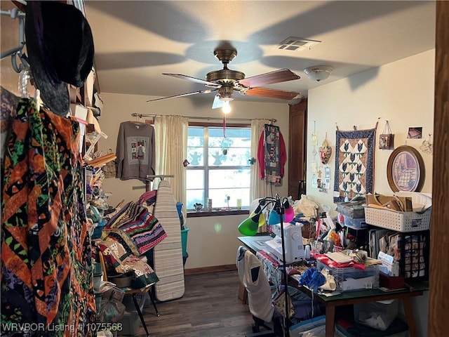 misc room with wood-type flooring and ceiling fan