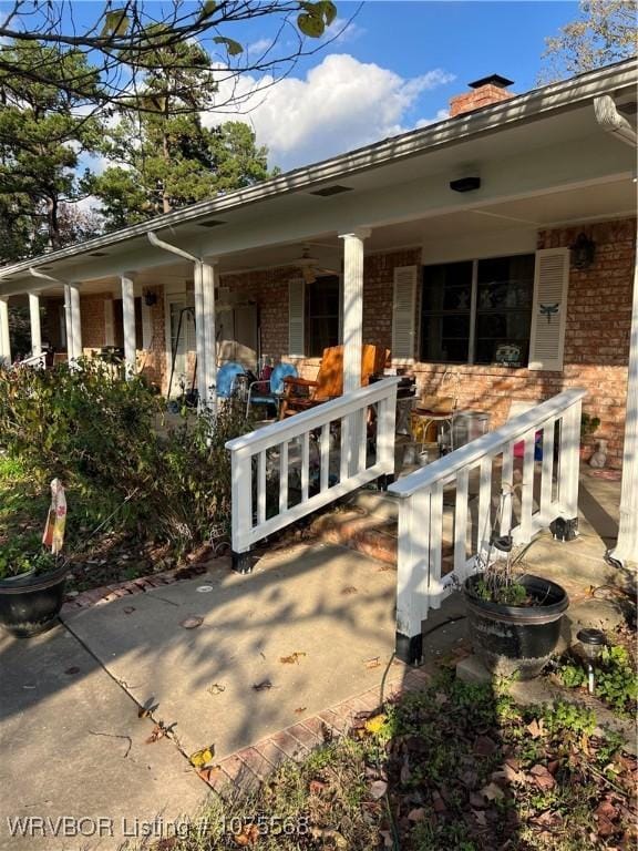 rear view of property with a porch