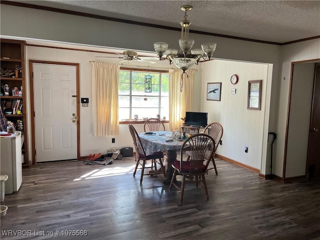 dining space featuring a textured ceiling, crown molding, dark hardwood / wood-style flooring, and ceiling fan with notable chandelier