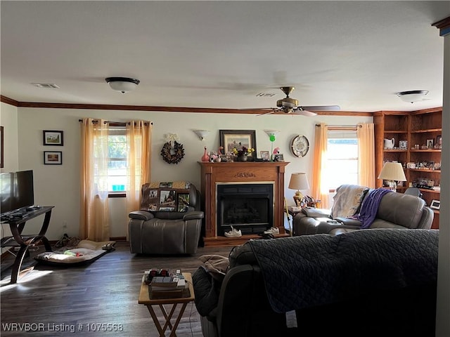 living room with ceiling fan, a healthy amount of sunlight, dark hardwood / wood-style flooring, and crown molding